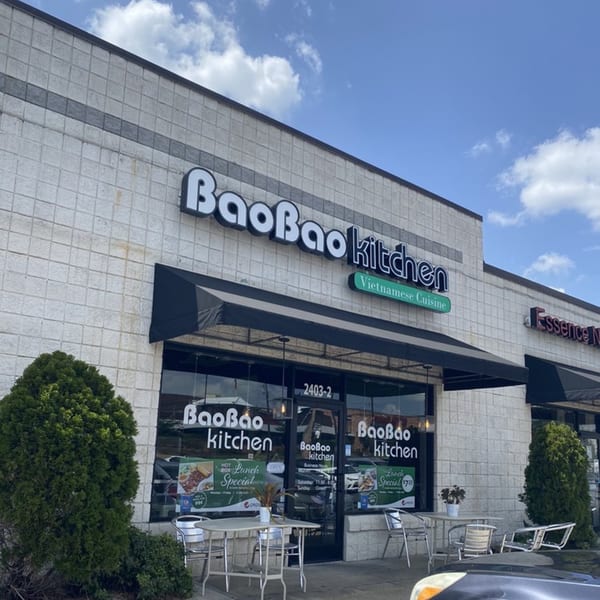 Exterior of BaoBao Kitchen, a Vietnamese restaurant, with outdoor seating and a black awning.